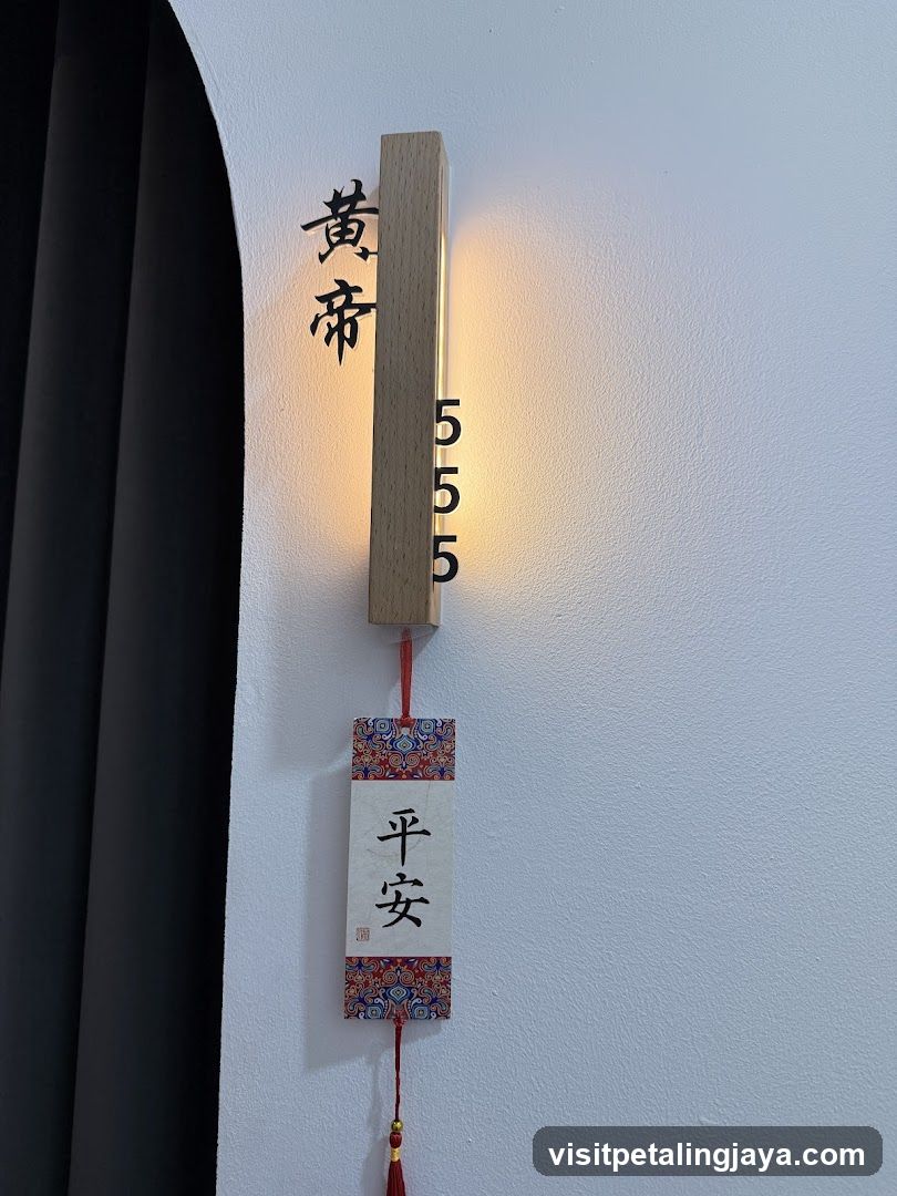 Wall-mounted wooden sign with Chinese characters and hanging charm