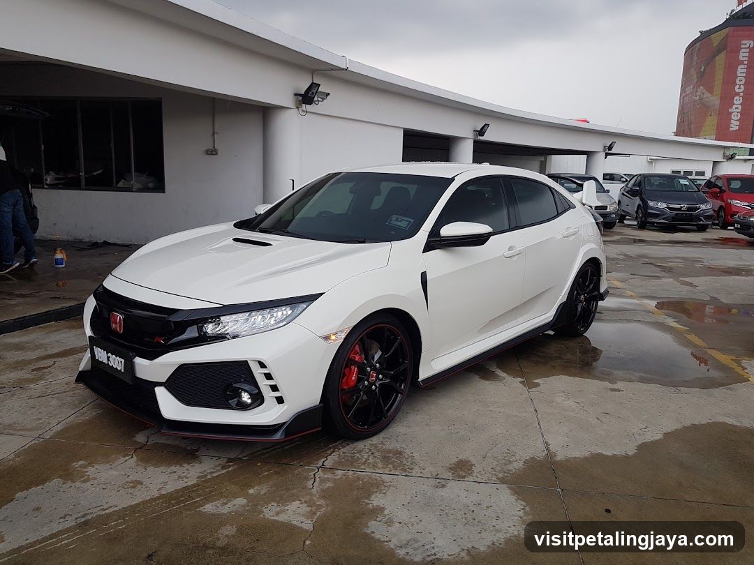 White Honda Civic Type R parked outside a building
