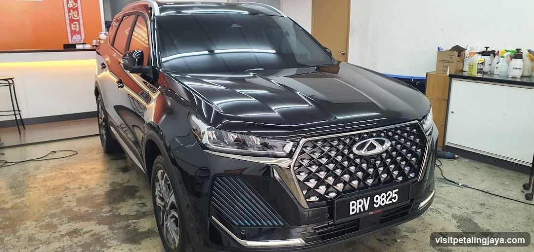 Black Infiniti QX60 in a workshop or garage setting