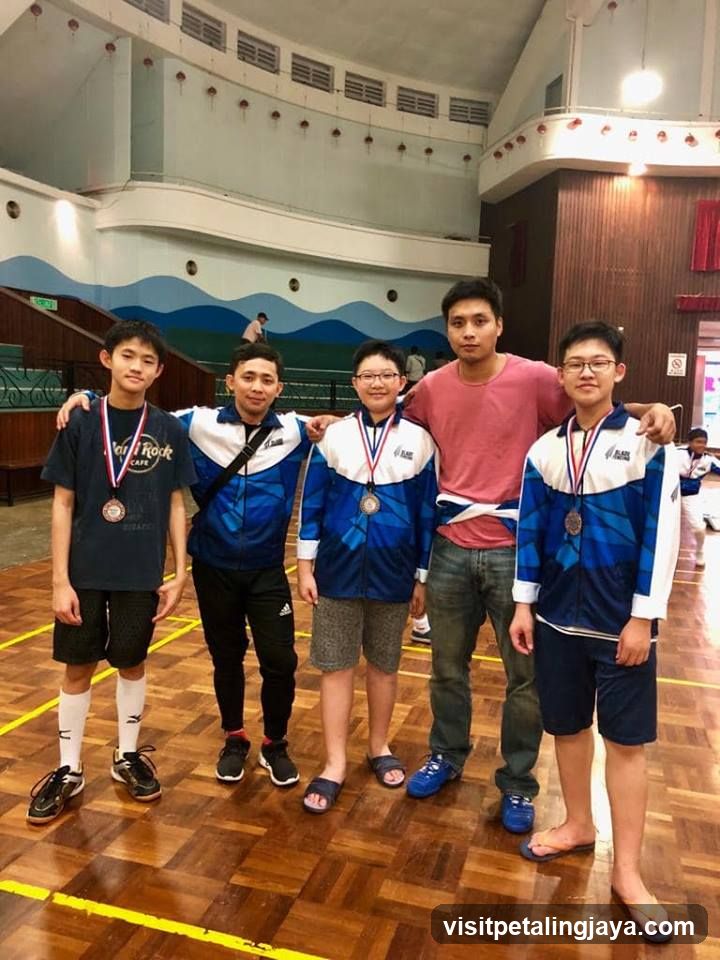 Group of athletes with medals in gymnasium