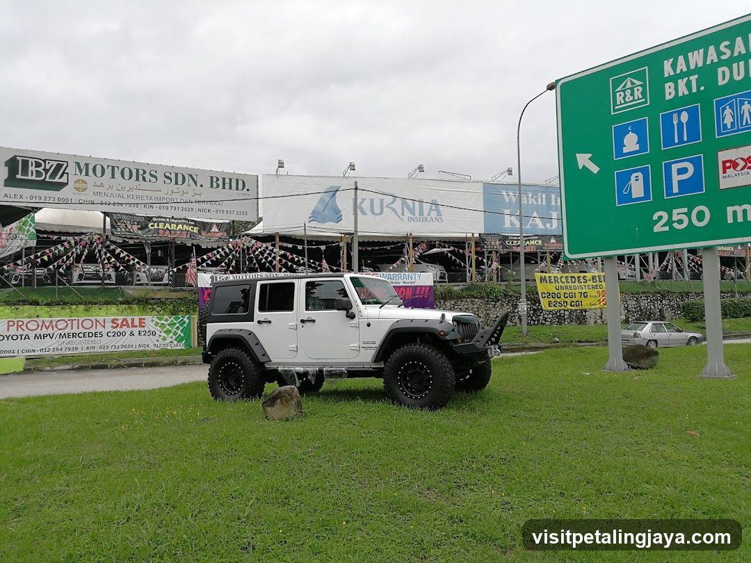 Jeep Wrangler in parking lot near commercial area