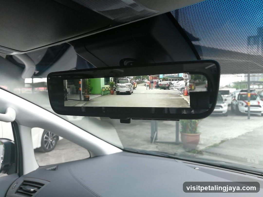 Rearview Mirror Reflection of Parking Lot
