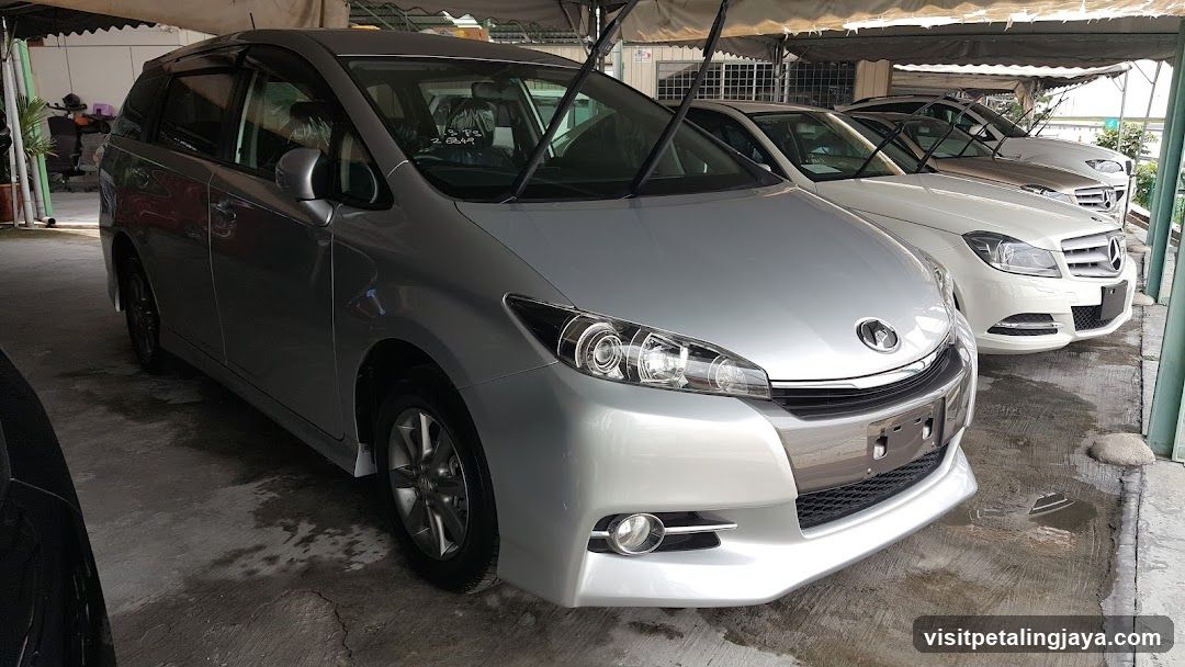 Silver Toyota Estima parked under carport