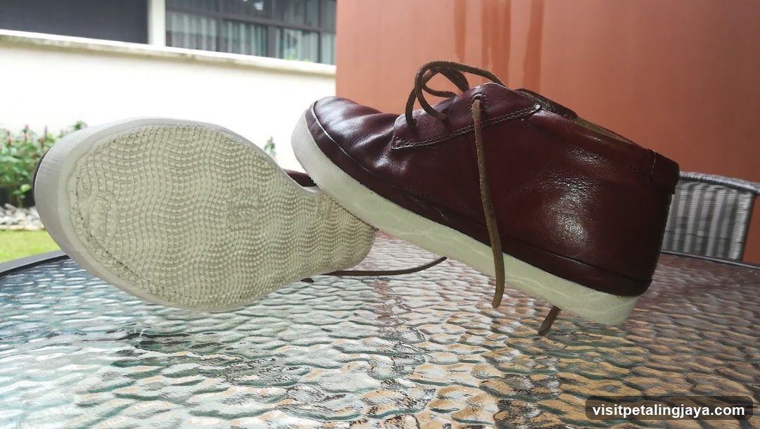 Maroon Leather Shoes on Glass Table