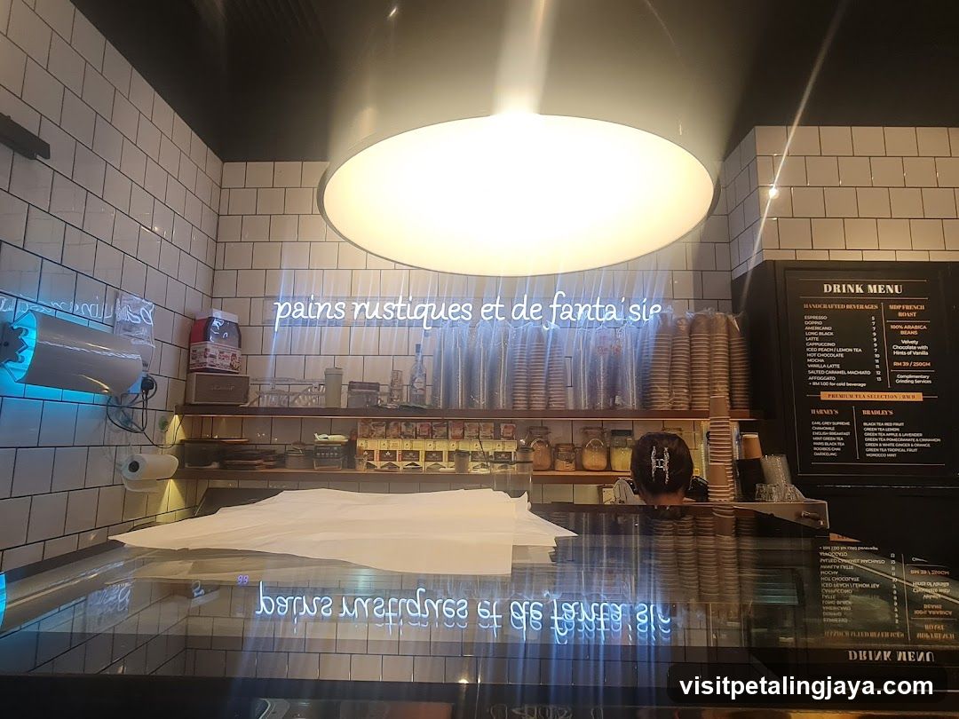 Interior of a coffee shop with tiled walls and menu board