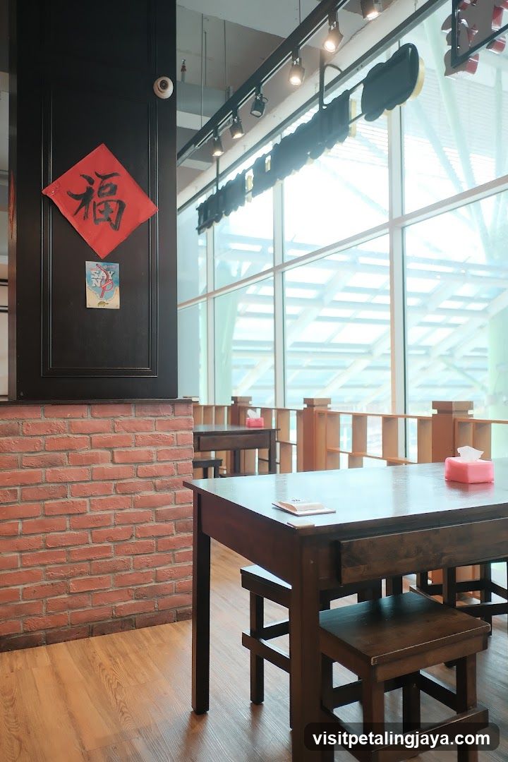 Interior of a restaurant with wooden tables and brick wall