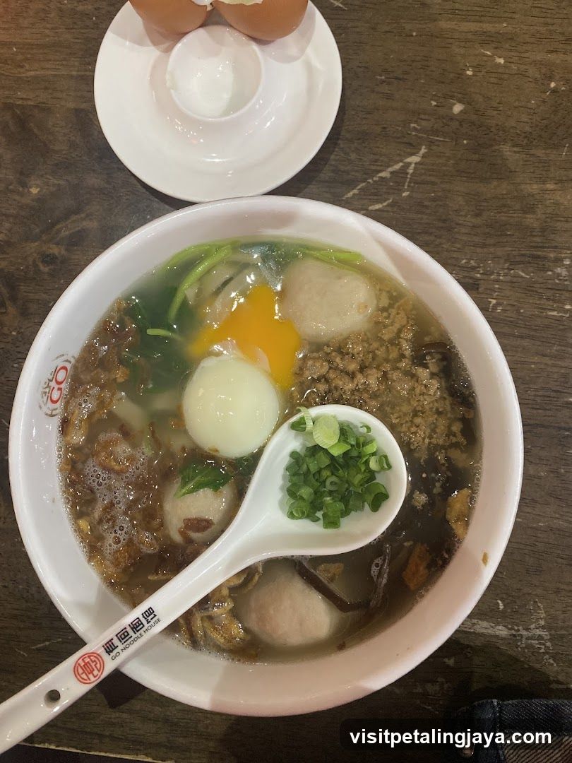 Bowl of Soup with Egg and Meatballs
