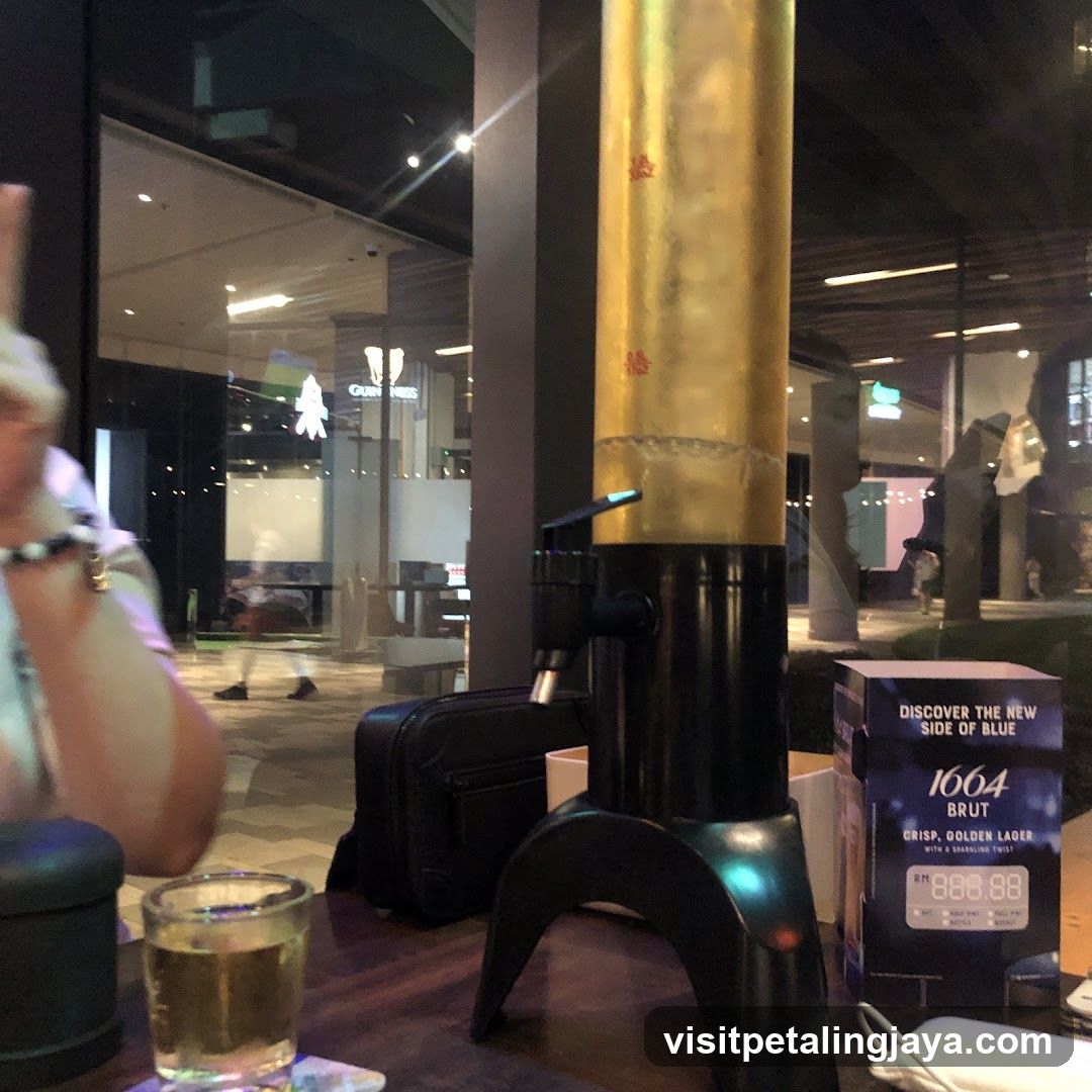Beer Dispenser and Glass at Bar