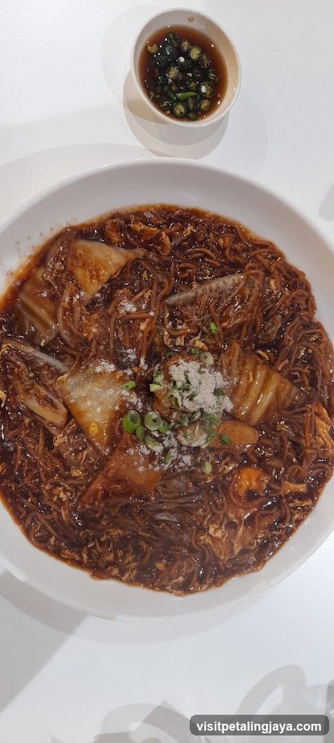 Bowl of Noodles with Sauce and Garnish