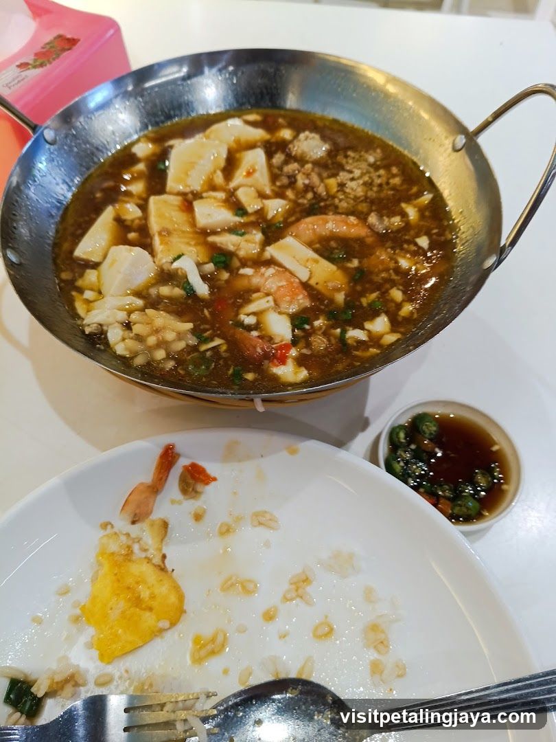 Dish in a metal pan with rice and dipping sauce