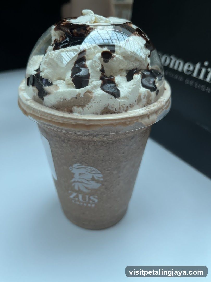 Zus Coffee Drink with Whipped Cream and Chocolate Drizzle