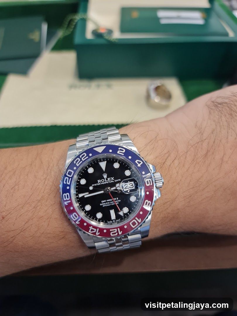 Rolex GMT-Master on wrist with green Rolex box in background