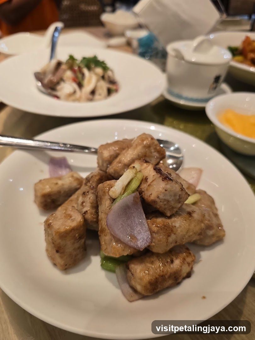 Dish of fried tofu with onions and green peppers