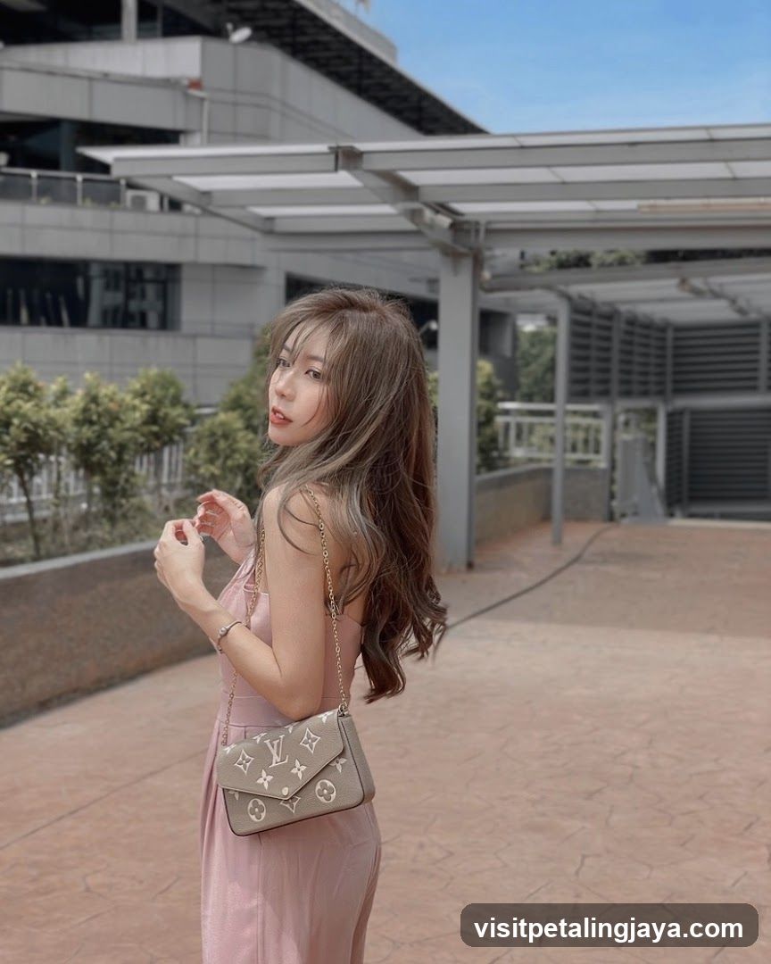 Woman in pink dress with LV bag