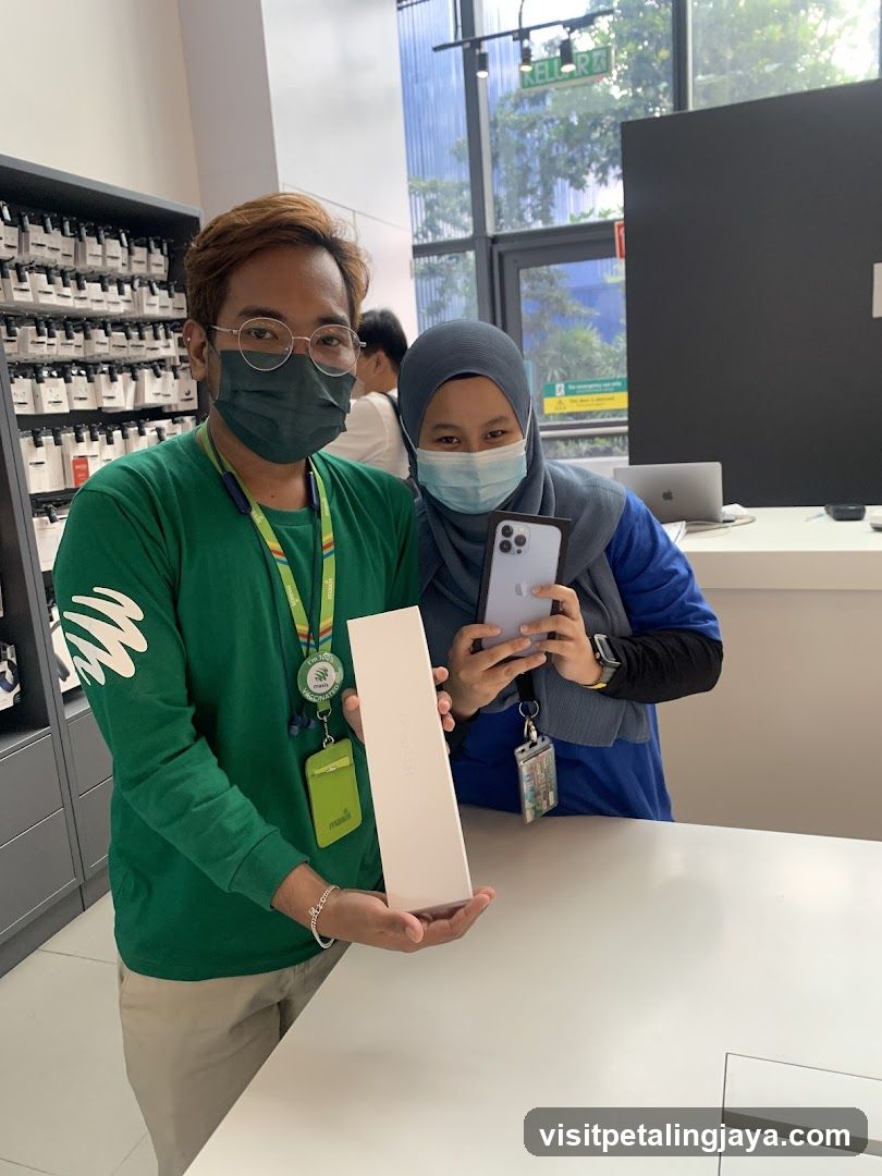 Staff showing iPhone box in store
