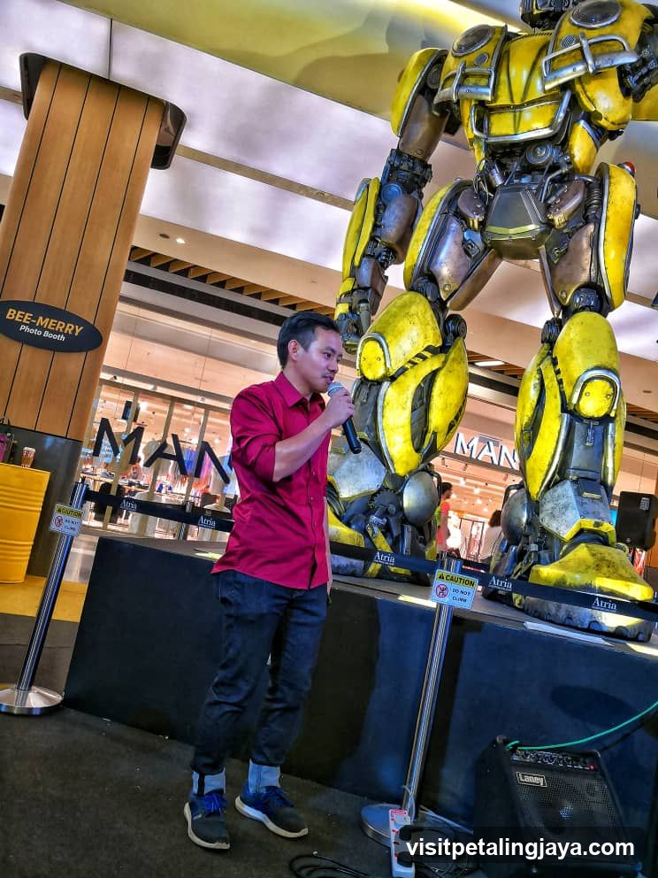 Man Speaking Near Bumblebee Statue
