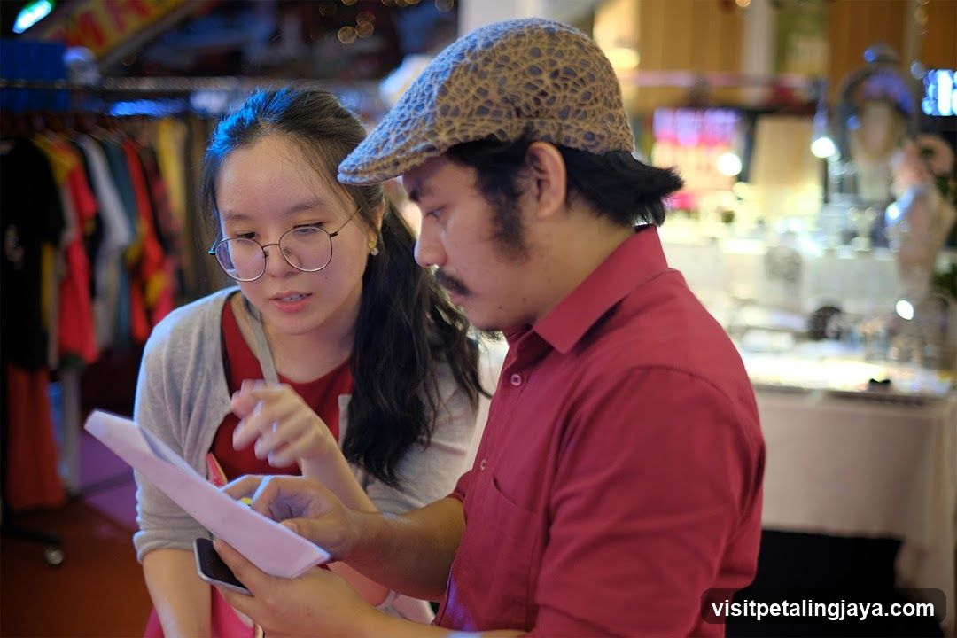 Two people reviewing documents in a shop