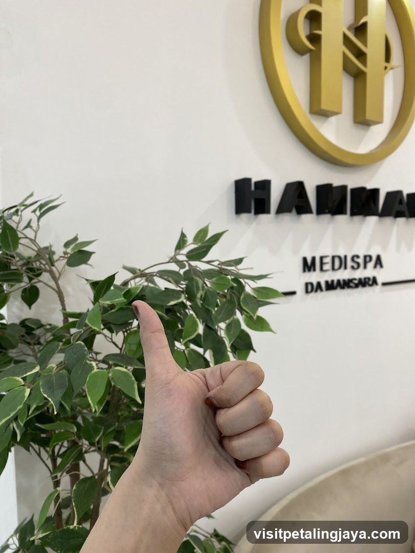 Hand giving thumbs up near Medispa signage