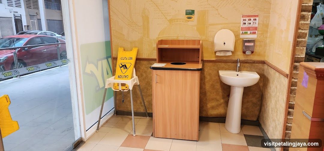 Restroom Area with Sink and Trash Bin