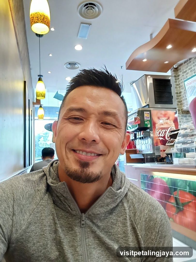 Man smiling in a cafe interior