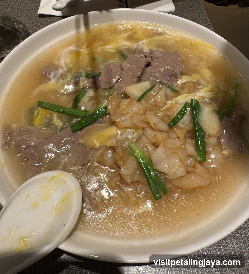 Bowl of Noodle Soup with Meat and Greens