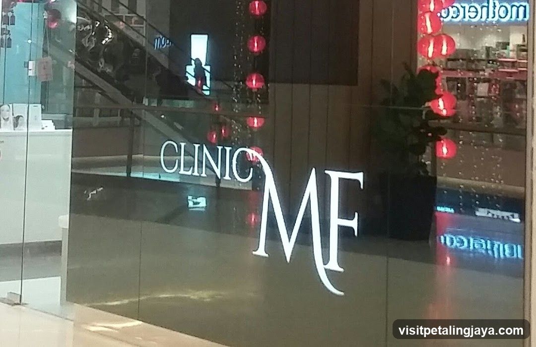 A glass storefront with illuminated signage reading 'CLINIC' and large stylized letters 'MF'. Red lanterns hang vertically on the right side, suggesting a festive or cultural theme. Inside, shelves of products are visible through the glass.
