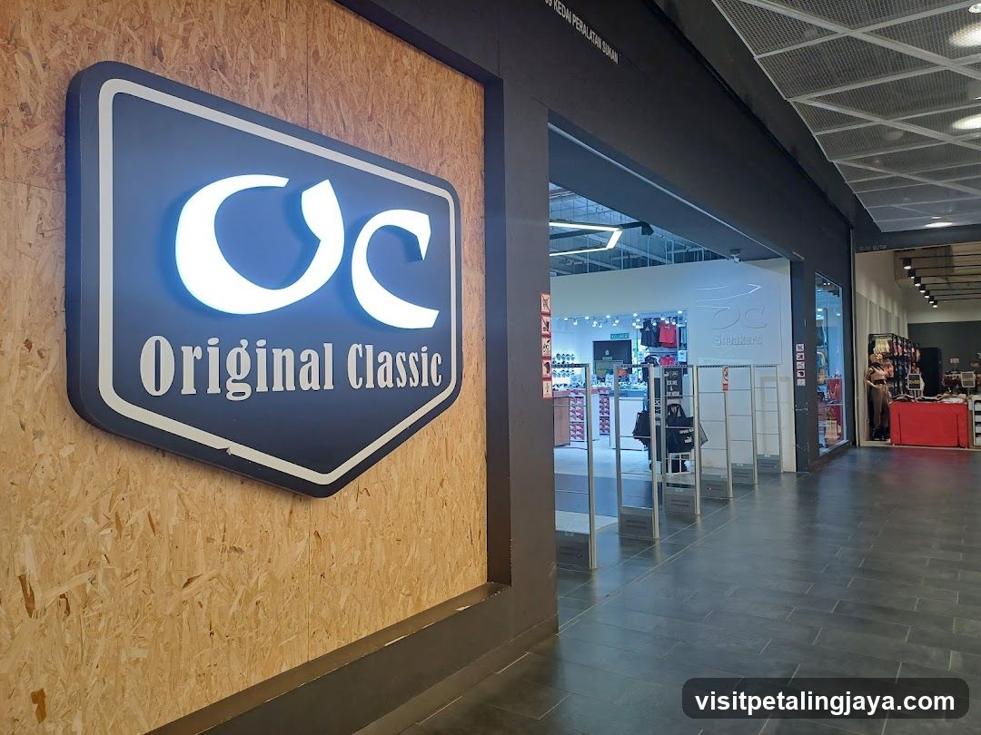 A storefront with a large illuminated sign displaying 'OC Original Classic' on an OSB panel wall. The entrance is visible, showing glass doors and interior lighting.