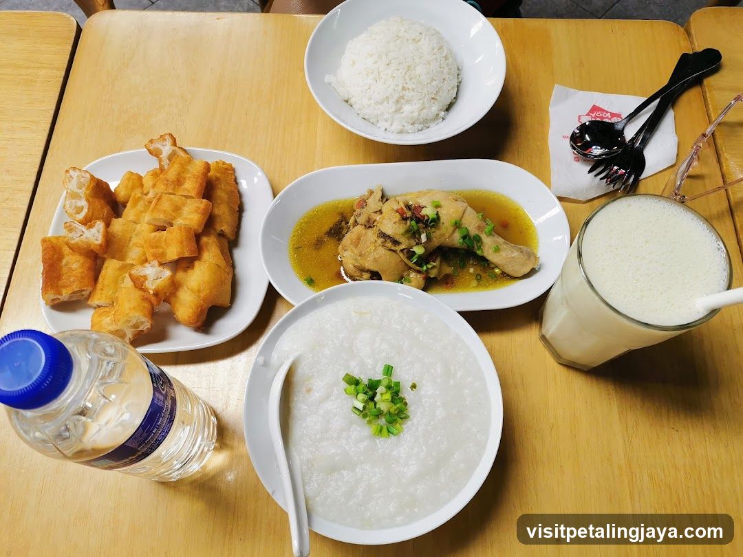 Breakfast Spread with Rice, Chicken, Fried Dough, Porridge and Drink
