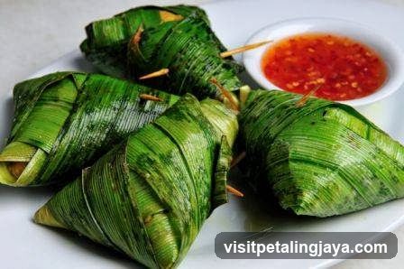 Green Leaf-Wrapped Food with Chili Sauce