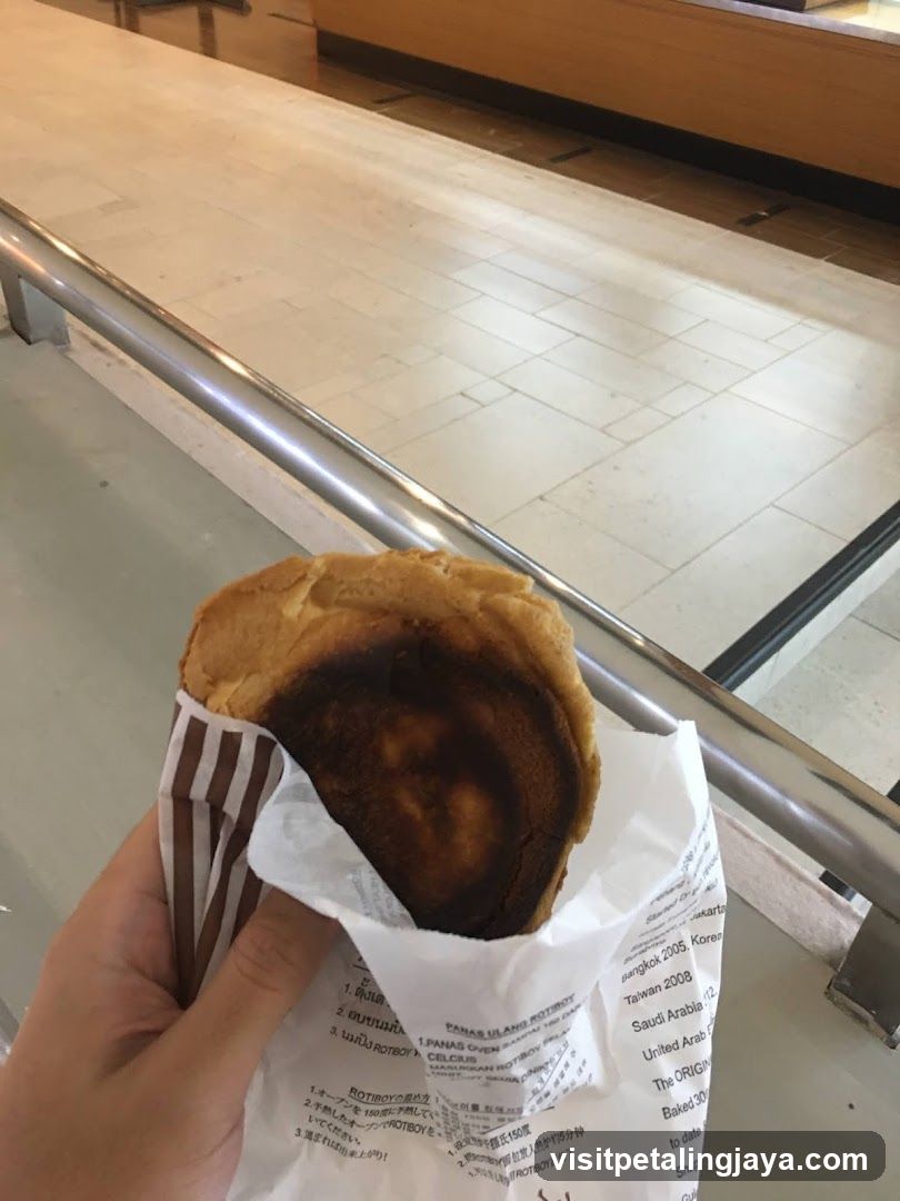 Hand holding a burnt pastry