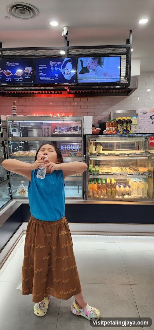 Girl drinking water in a cafe