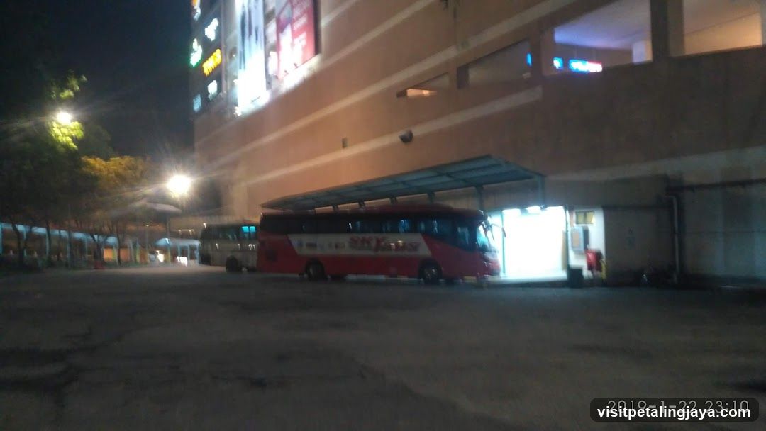 Night scene with buses parked near building entrance