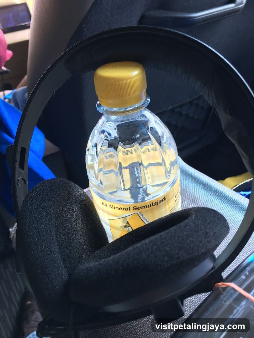 Bottle and Headphones in Car Interior