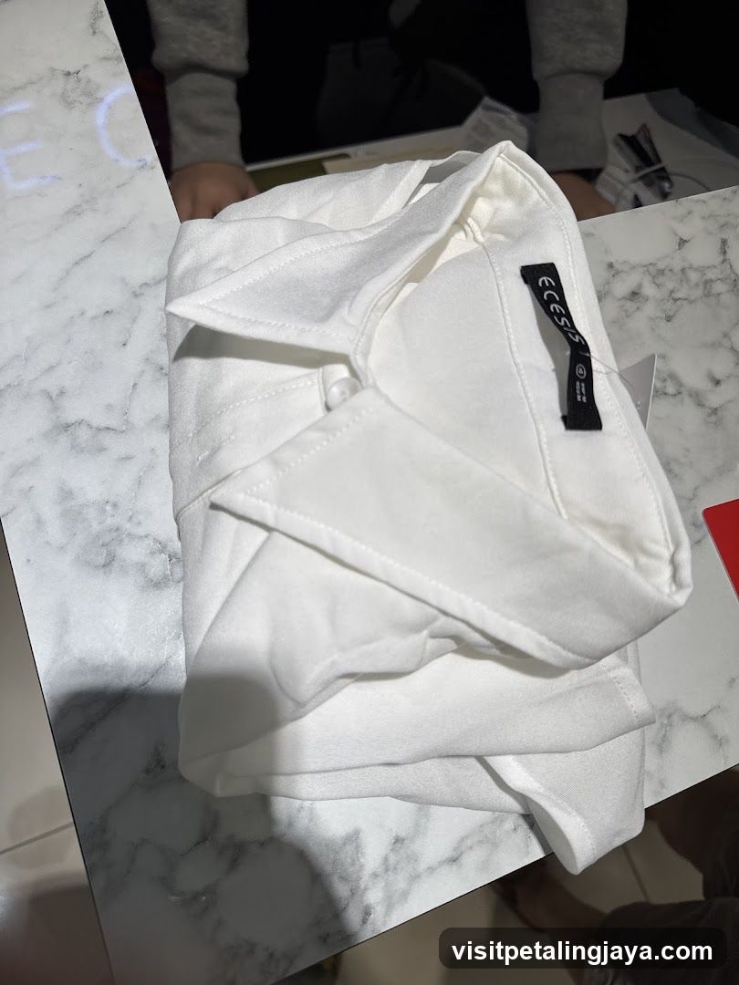 White folded shirt on marble table