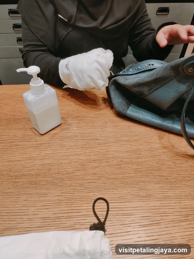 Hand Sanitizer and Bag on Table