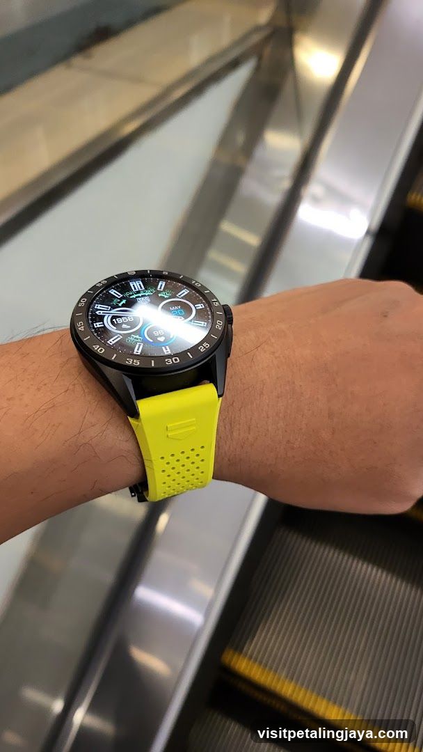Smartwatch on wrist near escalator