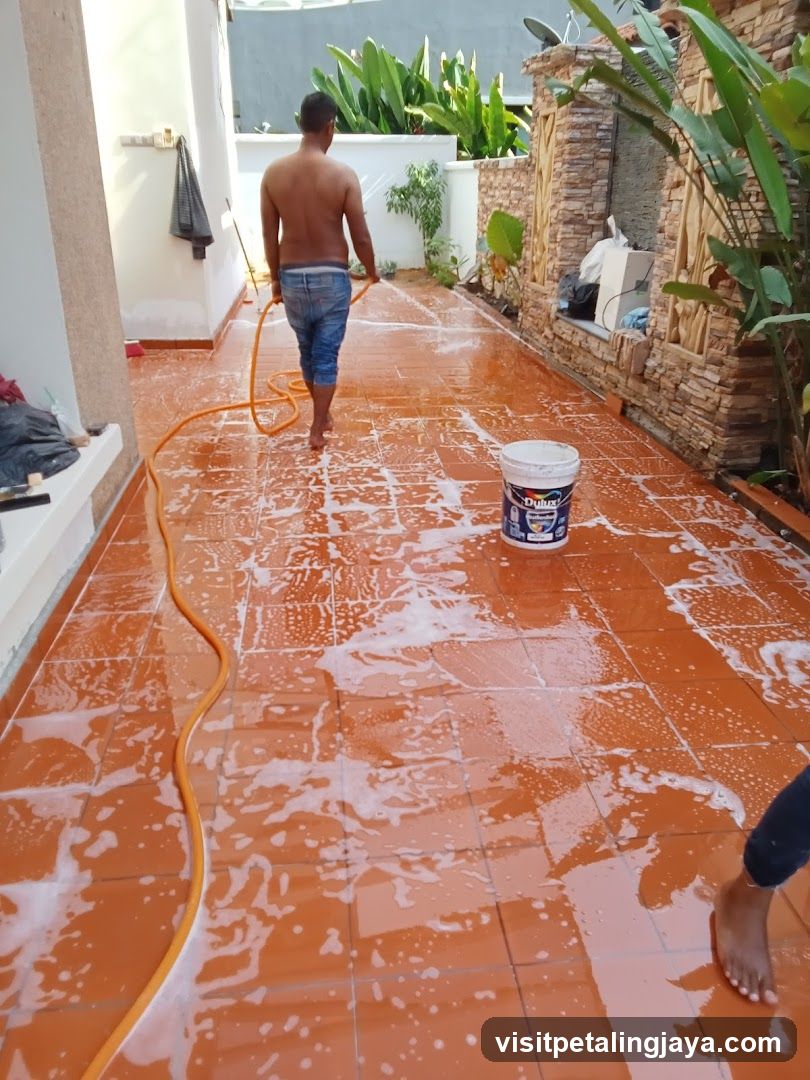 Man Washing Terracotta Patio Floor
