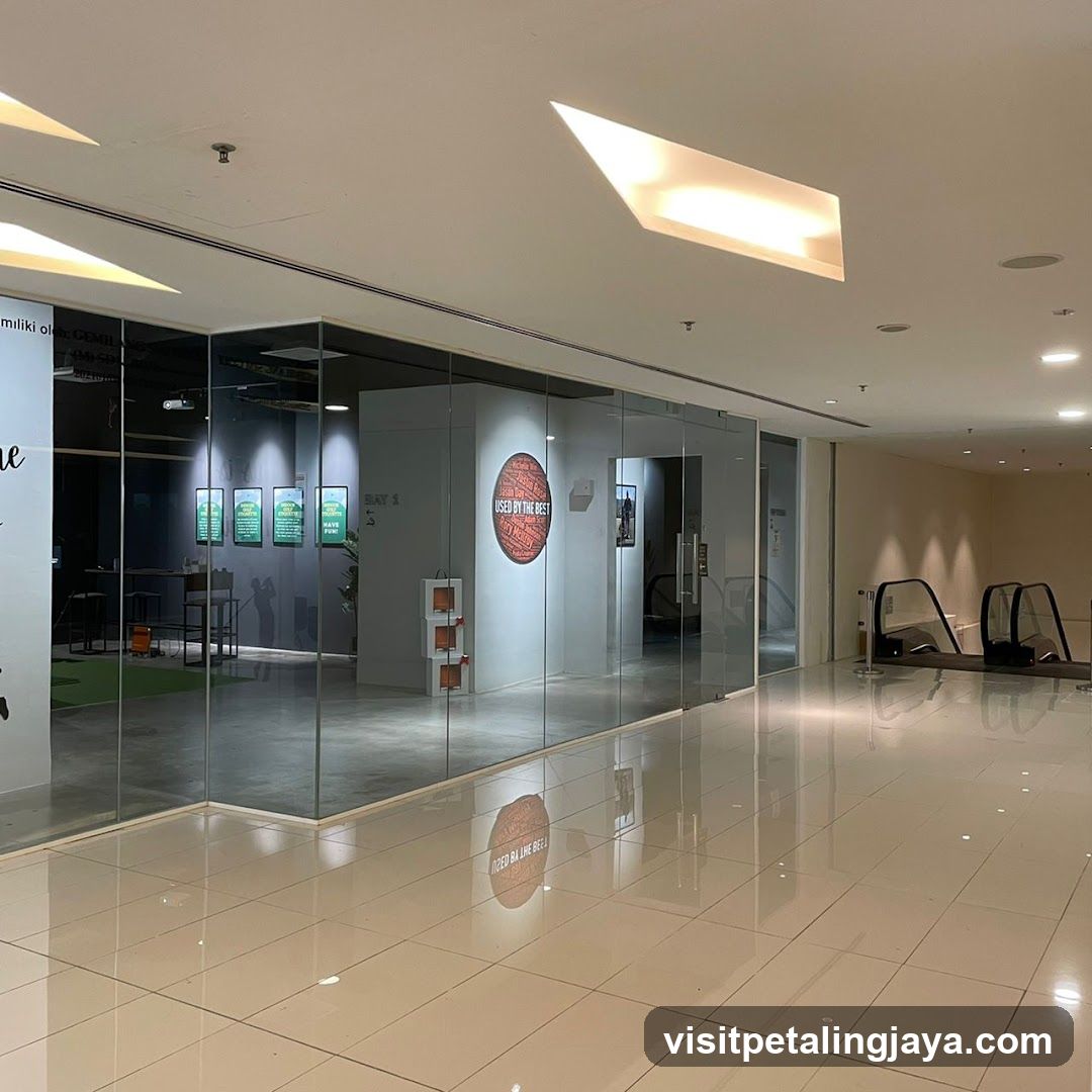 Interior of a modern commercial space with glass-walled shops and escalators