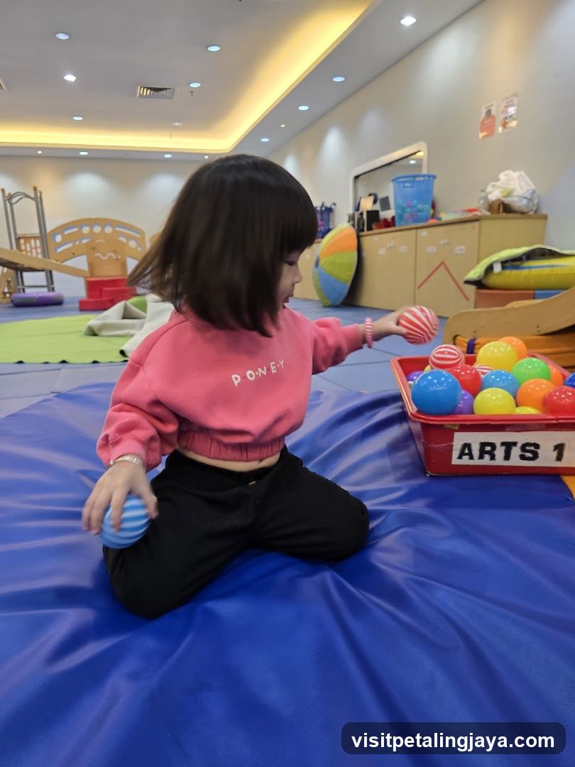 Child Playing with Balls in Playroom