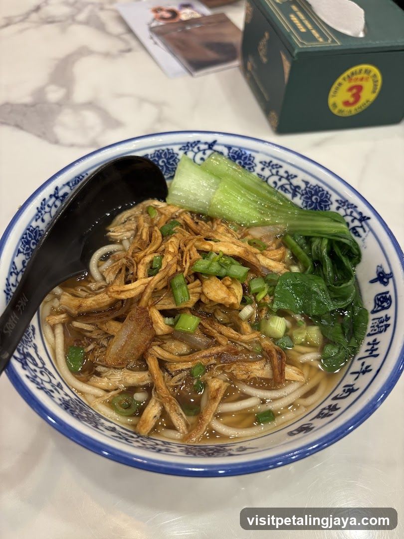 Bowl of Noodle Soup with Chicken and Greens