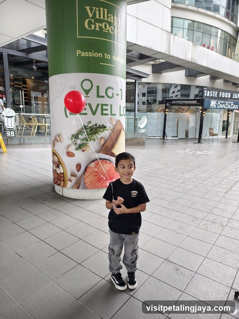 Boy with red balloon in mall