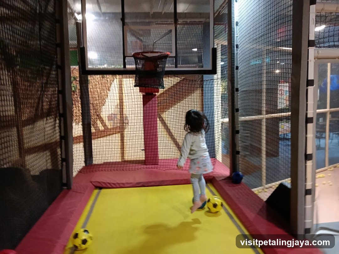 Child Playing with Balls on Trampoline