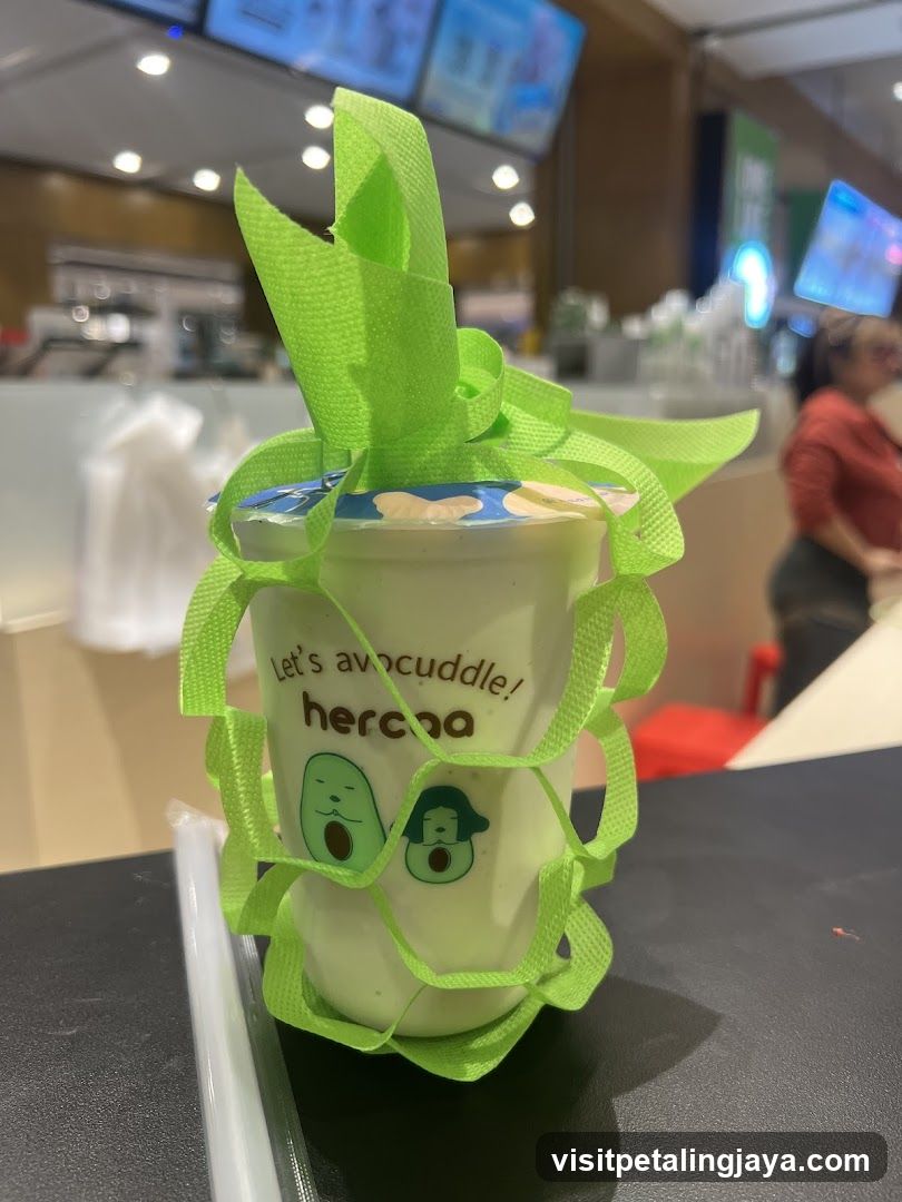 Avocado-themed drink cup with green ribbon decoration