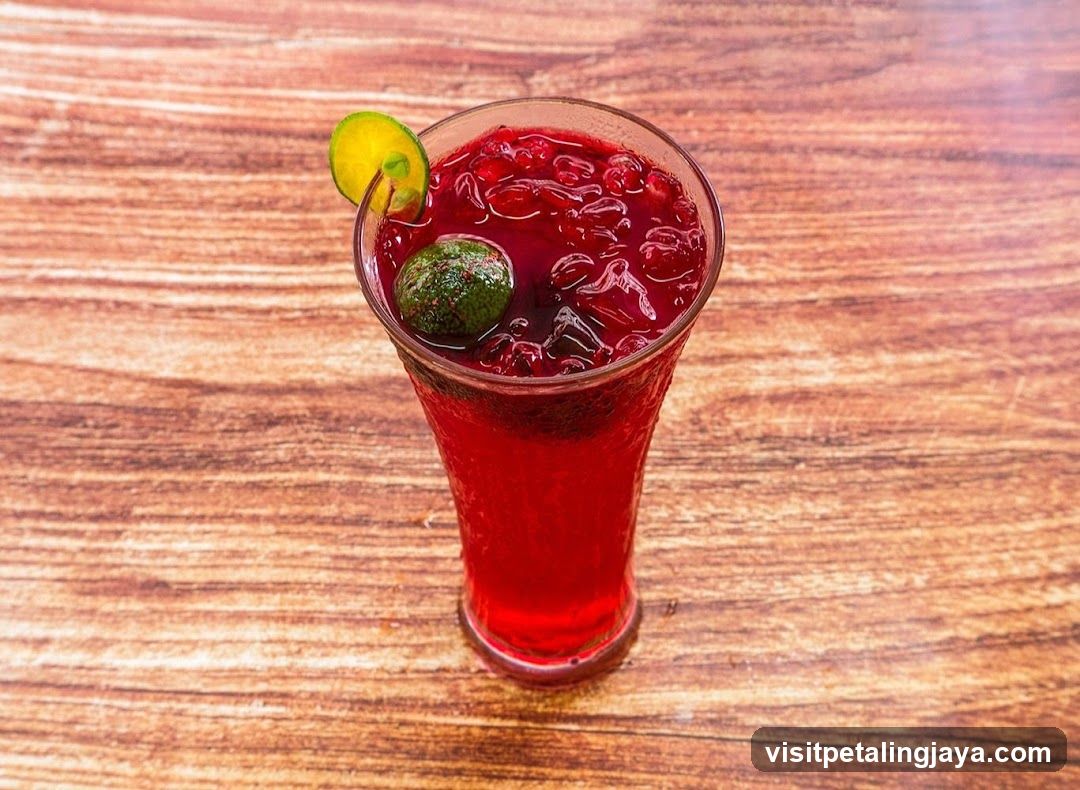 Red Fruit Drink with Lime Garnish