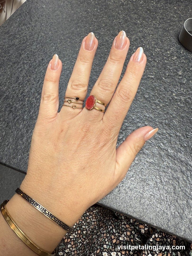 Hand with rings and bracelet on table