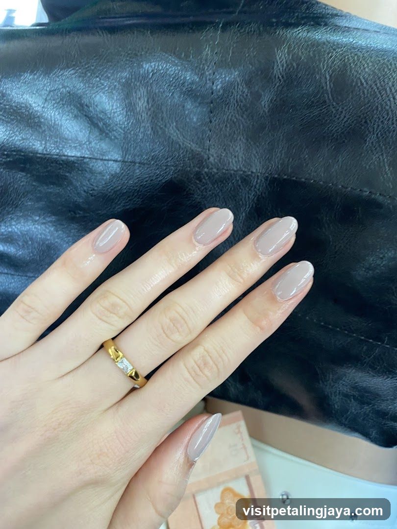Hand with manicured nails and ring