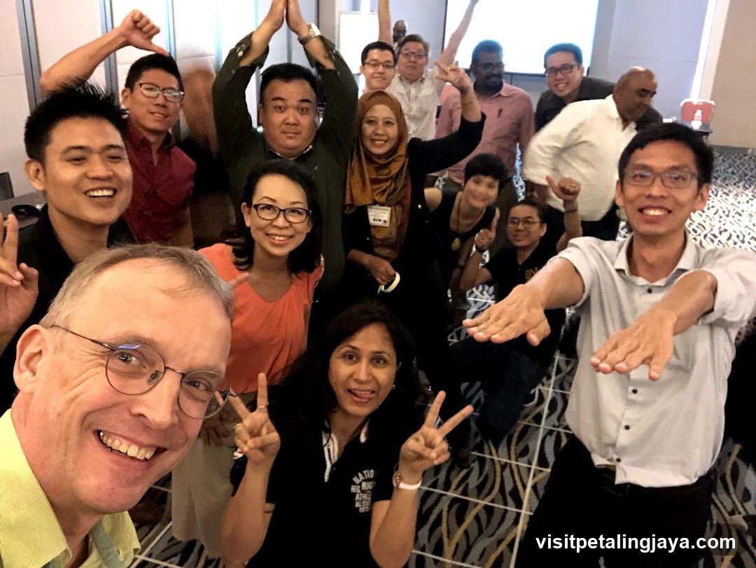 Group selfie with diverse people indoors