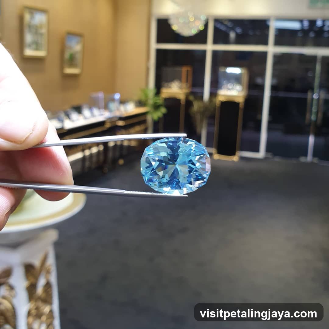 Blue Gemstone Held by Tweezers