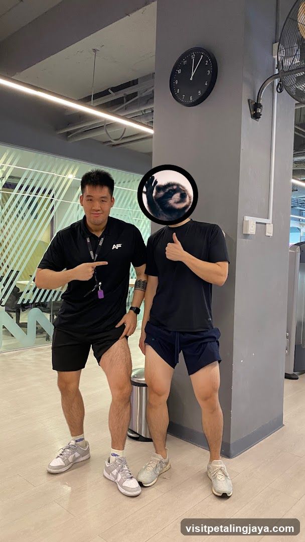 Two men in gym attire posing indoors