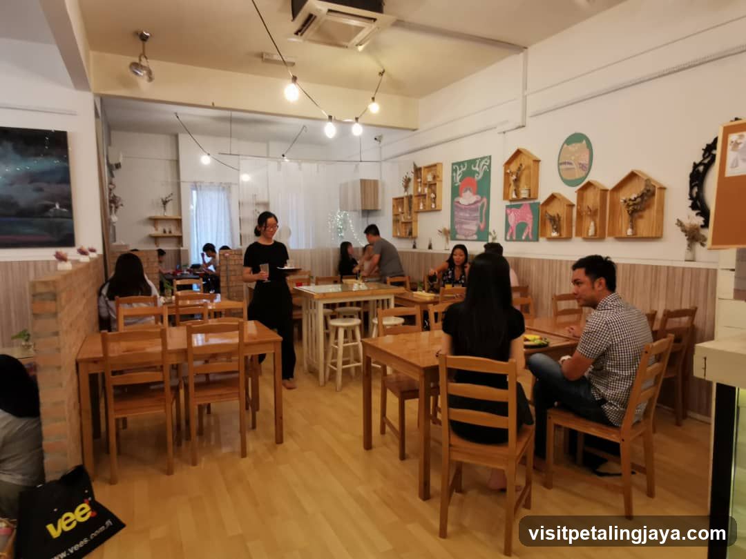 Interior of a cozy café with wooden furniture and string lights.